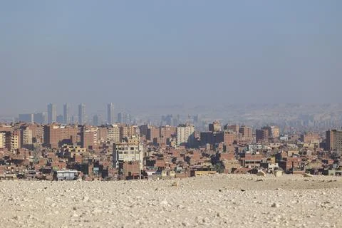 View from the pyramid complex in Giza, Egypt, to the high-rise apartment Stock Photos