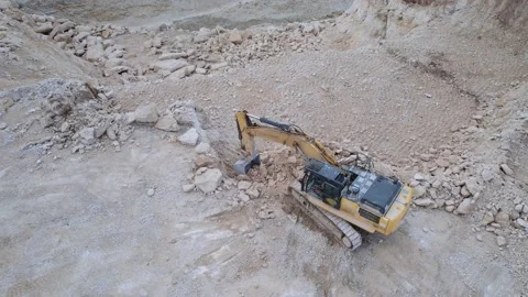 View from quadcopter of yellow crawler excavator working on open pit. Shot of Video stock 207751602