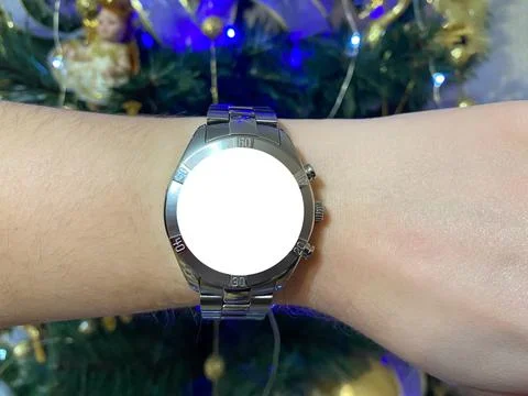 A view of the quartz watch dial with a stainless steel strap on the arm Stock Photos