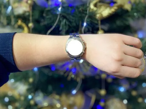 A view of the quartz watch dial with a stainless steel strap on the arm Stock Photos