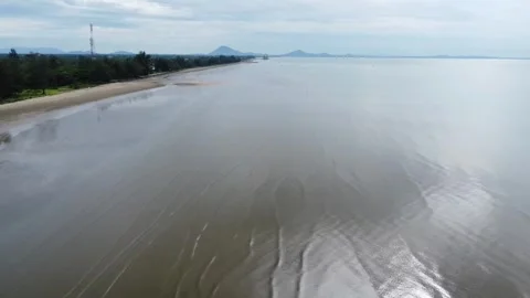 View of a quiet beach, with a beautiful stretch of sand in Pagatan Stock Footage 264797115