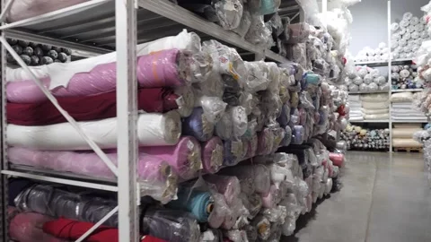View of a rack with rolls of multicolored fabrics 库存影片 165237124