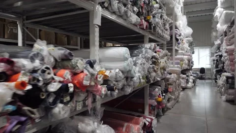 View of a rack with rolls of multicolored fabrics Stock Footage 167787750