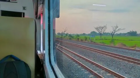 View of the rail line outside the train window, traveling by passenger train Stock Photos
