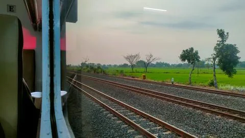 View of the rail line outside the train window, traveling by passenger train 写真素材
