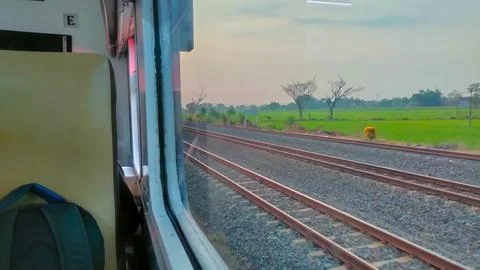 View of the rail line outside the train window, traveling by passenger train Stock Photos