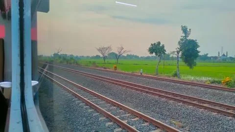 View of the rail line outside the train window, traveling by passenger train Stock Photos