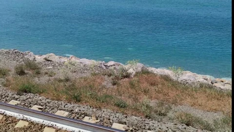 View of the rails against the background of the sea while the train is moving. Stock Footage 201884340