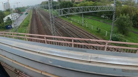 View of the railway track down from the window of a train crossing the bridge. Stock Footage 162463550