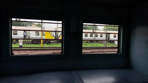 View of Railway Tracks and Passenger Train from Train Window Stock Footage 341723716