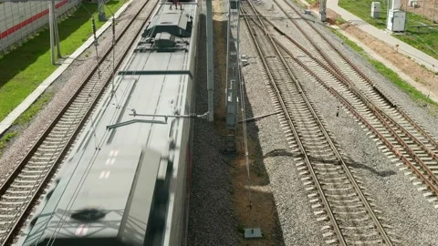 Up view of railways and electrical train passing by. Stock Footage 135575388