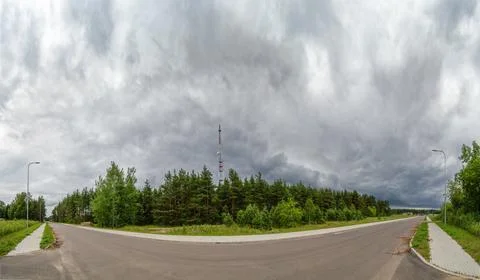 View of rain clouds with forest and mobile tower antenna in the background Stock Photos