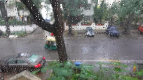 View of Rain drops from window during the Monsoon season. Stock Photos