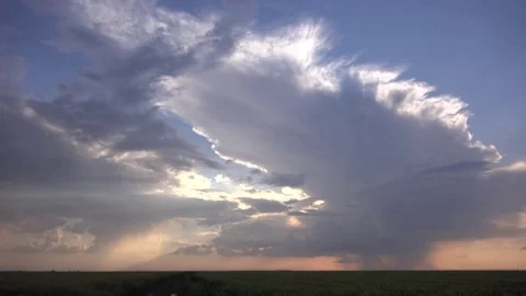 View of rain fall over cereal field in rural farmland at twilight tranquil place Stock Footage 81987177