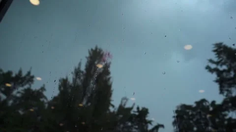 View of Rain Falling Through a Glass Stock Footage 293412890