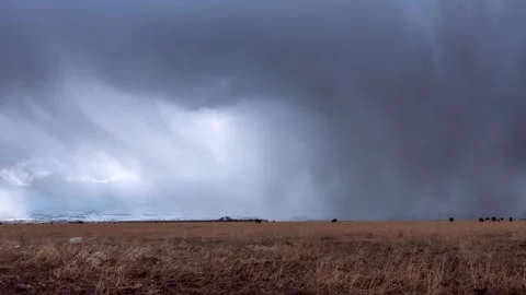 View of a rain shower over a field in the United States. Stock-Footage 344411323