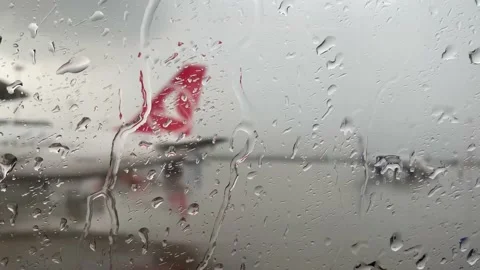 The view from the rain-splattered window of the plane and the take-off field Stock-Footage 213165724