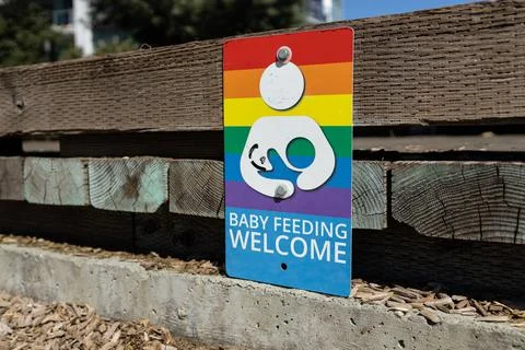 View of rainbow sign on the playground with text Baby Feeding Welcome Stock Photos