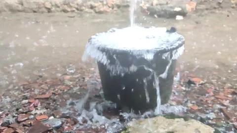 View of rainwater flowing into buckets through gutters Stock Footage 219739025