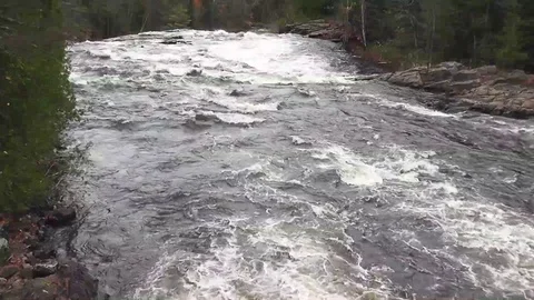 View of rapid river going towards a waterfall with sound of the raging water Stock Footage 90176704