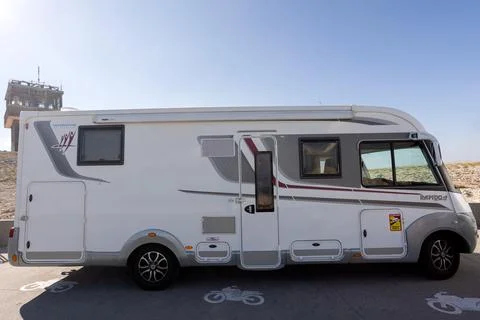 View of a Rapido 8096 df brand motorhome parked on the side of a road Stock Photos