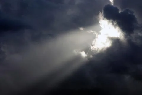 View on the rays of the sun shine trough dark clouds Stock Photos