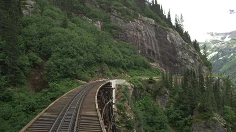 View from rear of train as it passes over bridge and through tunnel in Skagway, Stock Footage 36313287