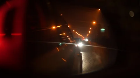 View of the rear-view mirror in a car at night. Stock Footage 124065452