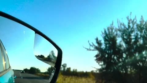 View in the rear view mirror of a car. Road trip. Summer car trip. Road Video stock 261219942