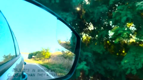 View in the rear view mirror of a car. Road trip. Summer car trip. Road Video stock 261220054