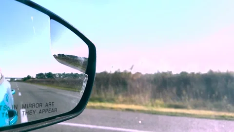 View in the rear view mirror of a car. Road trip. Summer car trip. Road Stock-Footage 262534636