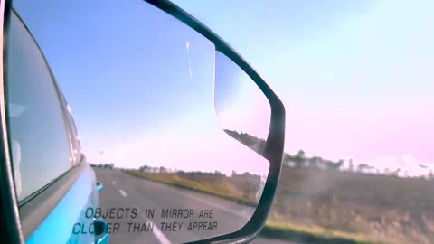 View in the rear view mirror of a car. Road trip. Summer car trip. Road Stock-Footage 262771813
