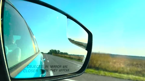 View in the rear view mirror of a car. Road trip. Summer car trip. Road Stock Footage 263729395