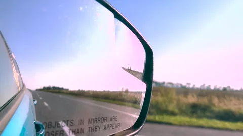 View in the rear view mirror of a car. Road trip. Summer car trip. Road Stock Footage 263729446