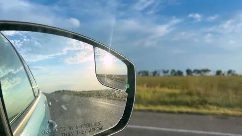 View in the rear view mirror of a car. Road trip. Summer car trip. Road Stock Footage 307314476
