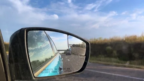 View in the rear view mirror of a car. Road trip. Summer car trip. Road Stock Footage 308967485