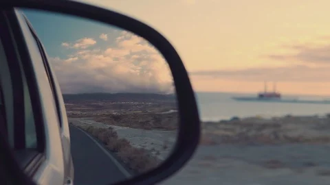 View in the rear view mirror while driving a car romance of long-distance travel Video stock 89813092