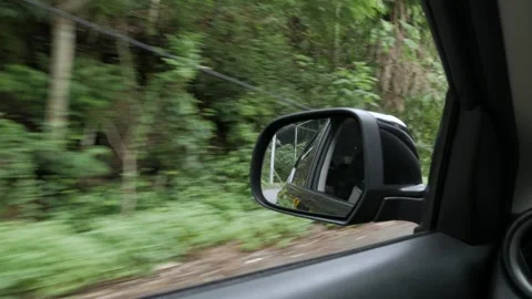 View in the rear view side mirror of a automobile car 動画素材 282335136