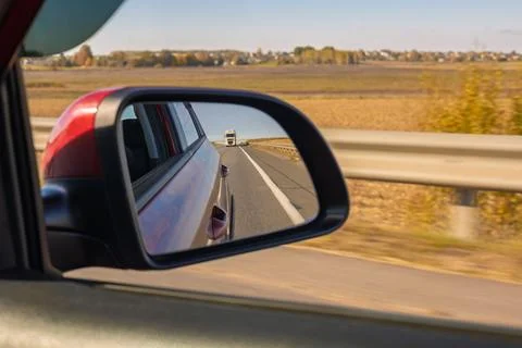 View in the rear view side mirror of a auto, driving a red car Photos