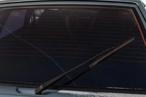 View to the rear window wiper that remove the melted snow and dirt from the w Stock Photos