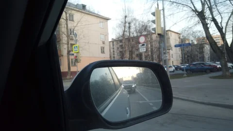 The view from the rearview mirror is of the car. Driving through the busy city Stock Footage 120593426