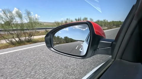 View of the rearview mirror on a highway Stock Footage 275251214