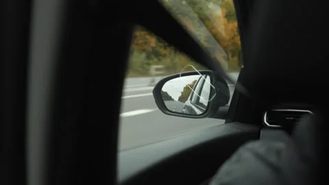 View of the rearview mirror through the car window during a trip. Stock Footage 253502689