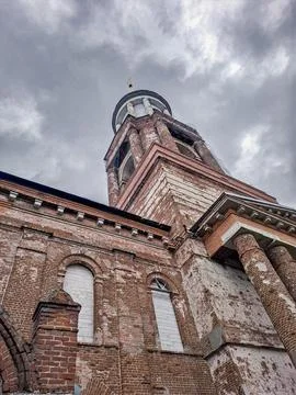 View of the red brick facade and bell tower of an old Orthodox church in Ye.. Stock Photos