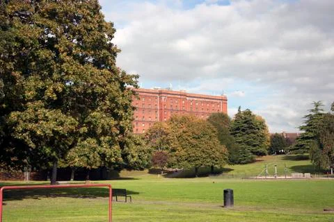 View of red brick warehouse as seen from park. Stock Photos
