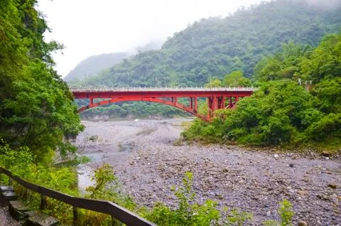 View of red bridge over river in Taroko National Park, Taiwan. Taroko Gorge s Stock Photos