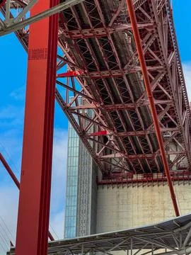 View of red bridge structure at anchorage block at blue sky with clouds on Stock Photos