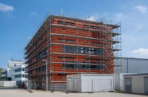 View of a red building under reconstruction on the background of the blue sky Fotos de archivo