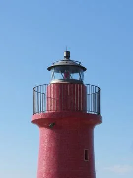 A view of the red harbor lighthouse along the Tuscany coastline Grosseto Italy Stock Photos