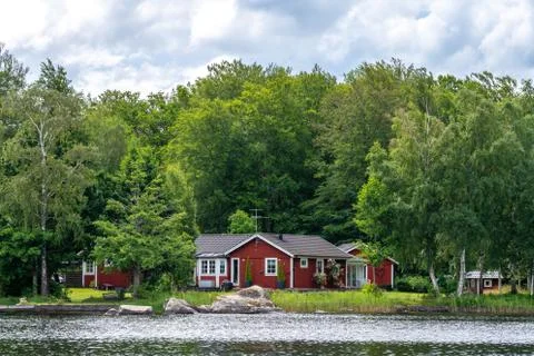 View on red holiday cabin by a lake in Stockholm archipelago, Sweden Stock Photos